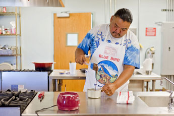 Candy maker Riley Ortiz mixes a batch of chocolate at the Community Pantry kitchen Thursday. © 2011 Gallup Independent / Cable Hoover 